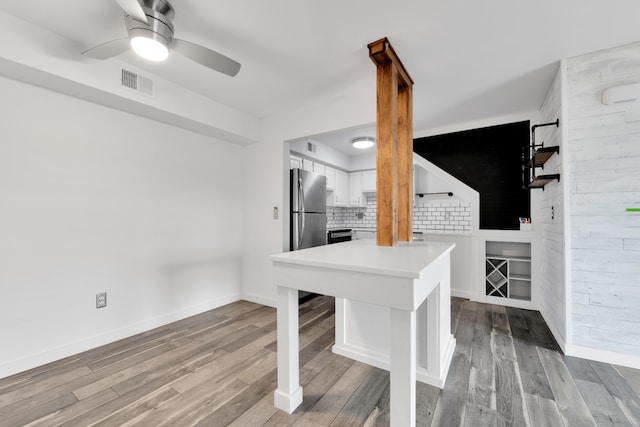 221 Pinewood Cir, Plymouth, MI 48170 - kitchen featuring freestanding refrigerator, white cabinetry, ceiling fan, and wood finished floors