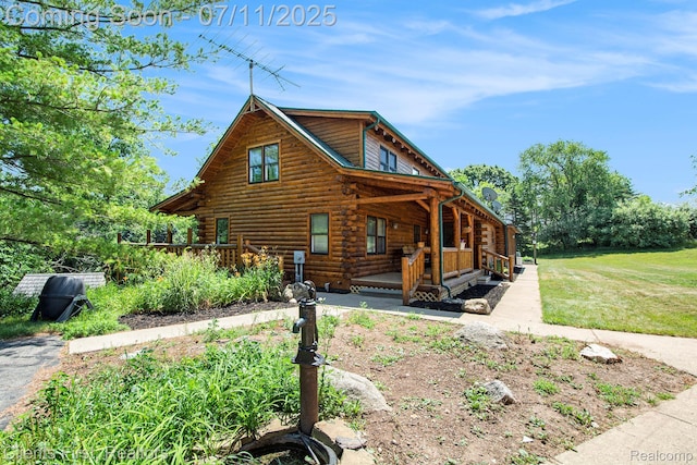 16501 Winters Rd, Grass Lake, MI 49240 - view of front of property with log exterior, covered porch, and a front yard