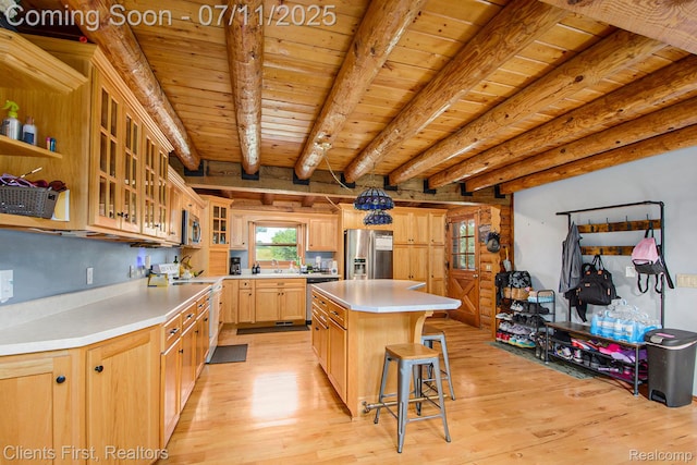16501 Winters Rd, Grass Lake, MI 49240 - kitchen with stainless steel appliances, light wood-style flooring, light brown cabinets, light countertops, and a wooden ceiling with exposed beams