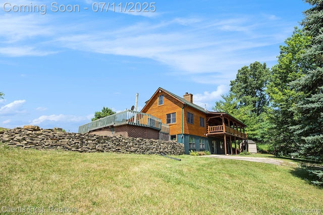 16501 Winters Rd, Grass Lake, MI 49240 - rear view of house featuring a chimney, a yard, and a wooden deck