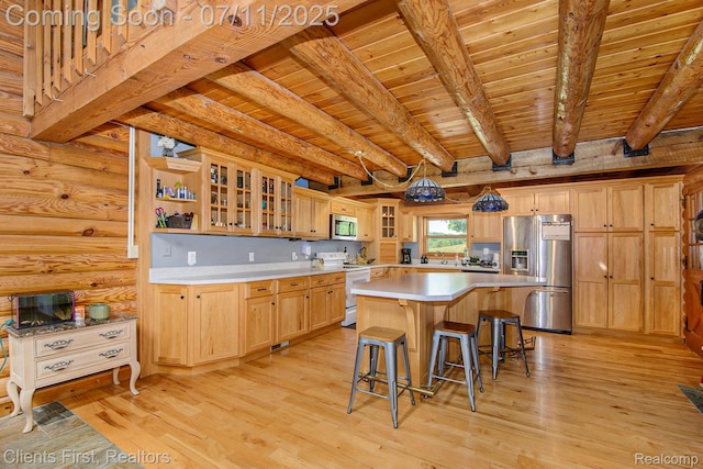 16501 Winters Rd, Grass Lake, MI 49240 - kitchen with appliances with stainless steel finishes, a wooden ceiling with exposed beams, light countertops, a kitchen bar, and light wood finished floors