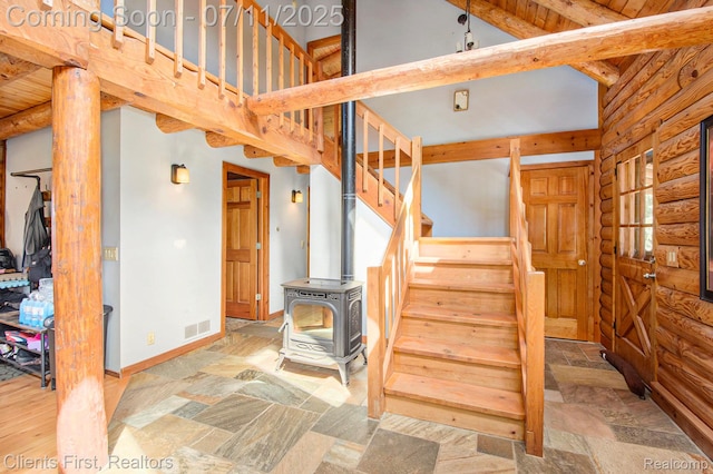 16501 Winters Rd, Grass Lake, MI 49240 - stairs with a wood stove, stone finish floors, and log walls
