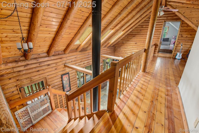 16501 Winters Rd, Grass Lake, MI 49240 - corridor featuring wood ceiling, log walls, wood-type flooring, and an upstairs landing