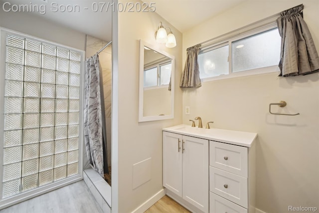 4309 Marr Ave, Warren, MI 48091 - full bath with plenty of natural light, a shower with curtain, vanity, and wood finished floors