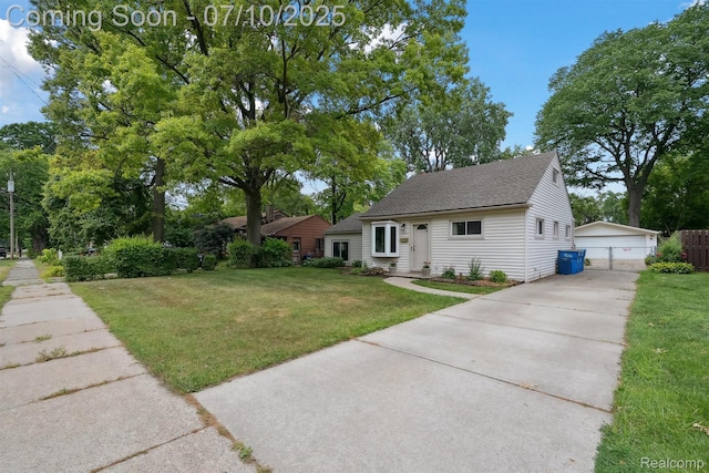 4309 Marr Ave, Warren, MI 48091 - view of front of house featuring a front yard, an outdoor structure, a detached garage, and a shingled roof