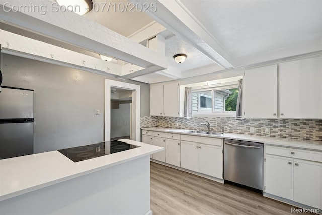 4309 Marr Ave, Warren, MI 48091 - kitchen featuring appliances with stainless steel finishes, decorative backsplash, light countertops, light wood finished floors, and white cabinets