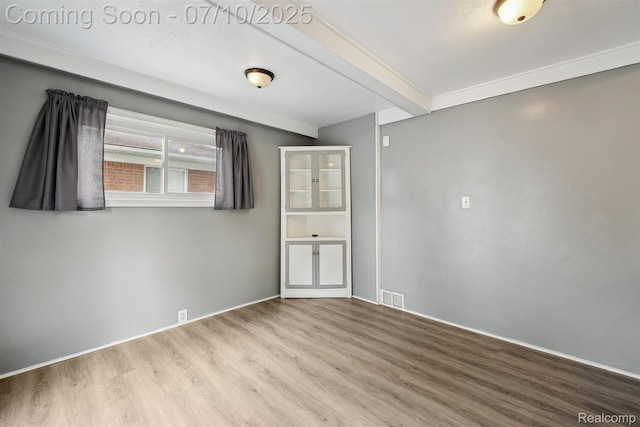 4309 Marr Ave, Warren, MI 48091 - empty room with wood finished floors and beamed ceiling