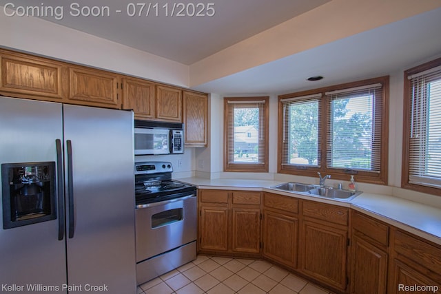 48600 Meadowcrest Dr, Macomb, MI 48044 - kitchen with appliances with stainless steel finishes, brown cabinets, light tile patterned flooring, and light countertops