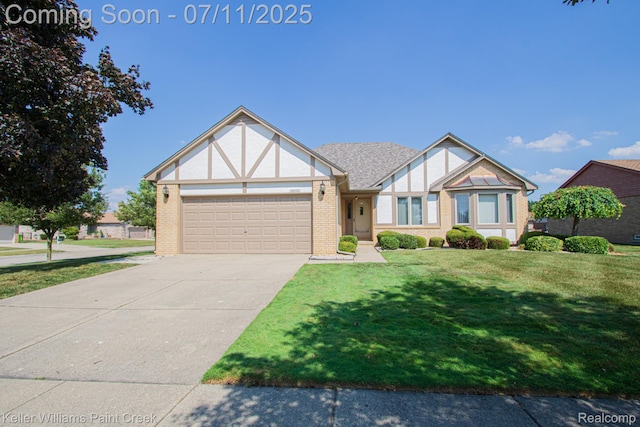 48600 Meadowcrest Dr, Macomb, MI 48044 - tudor house with an attached garage, concrete driveway, a front lawn, and brick siding