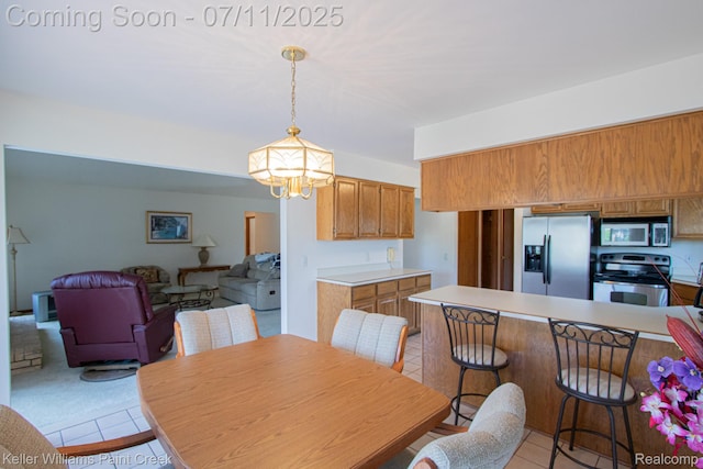 48600 Meadowcrest Dr, Macomb, MI 48044 - dining area with light tile patterned flooring and a chandelier