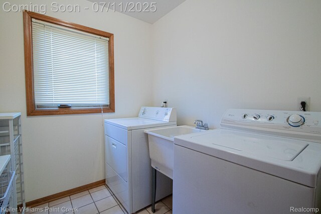 48600 Meadowcrest Dr, Macomb, MI 48044 - laundry area featuring washer and dryer and light tile patterned flooring