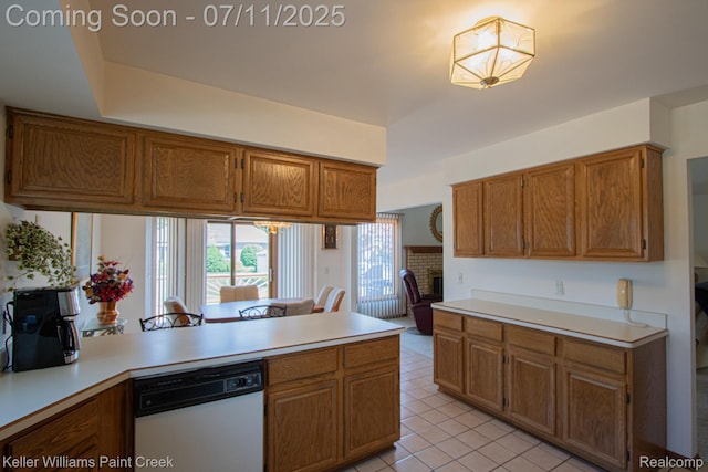 48600 Meadowcrest Dr, Macomb, MI 48044 - kitchen featuring a peninsula, dishwasher, light countertops, brown cabinetry, and light tile patterned floors