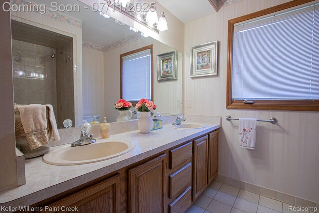 48600 Meadowcrest Dr, Macomb, MI 48044 - bathroom featuring double vanity, tile patterned flooring, and tiled shower