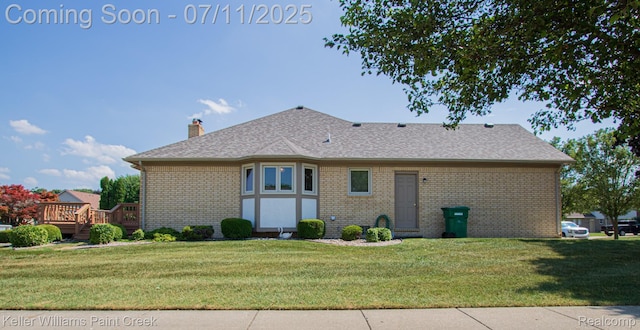 48600 Meadowcrest Dr, Macomb, MI 48044 - rear view of house featuring brick siding, a lawn, a chimney, a wooden deck, and roof with shingles