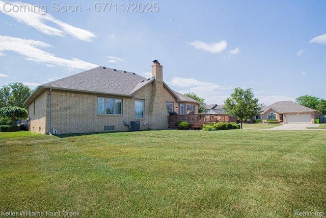 48600 Meadowcrest Dr, Macomb, MI 48044 - view of side of home featuring brick siding, a chimney, a wooden deck, and a yard
