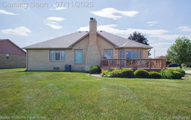 48600 Meadowcrest Dr, Macomb, MI 48044 - back of property with brick siding, a wooden deck, a chimney, a lawn, and a shingled roof