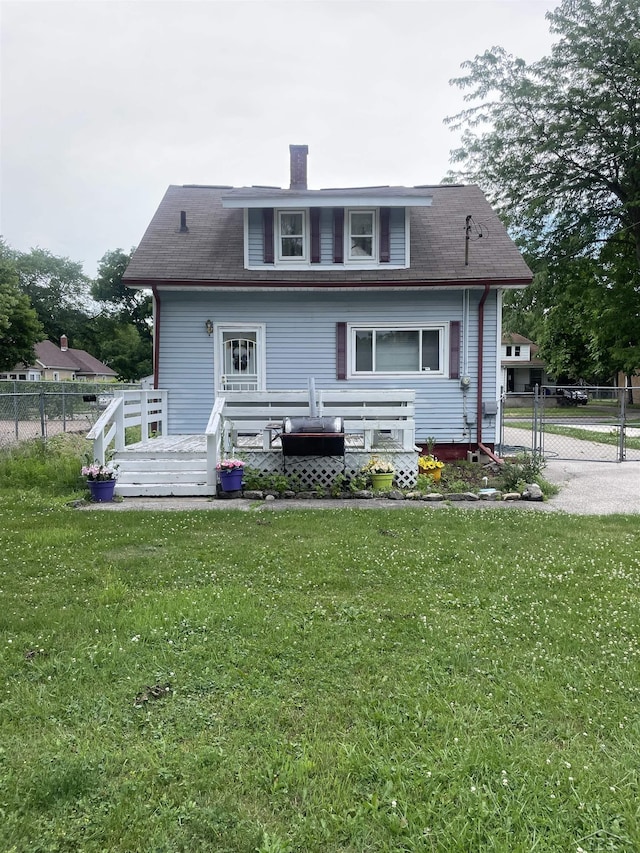2205 Owen St, Saginaw, MI 48601 - rear view of house with a chimney, a deck, a gate, and a shingled roof