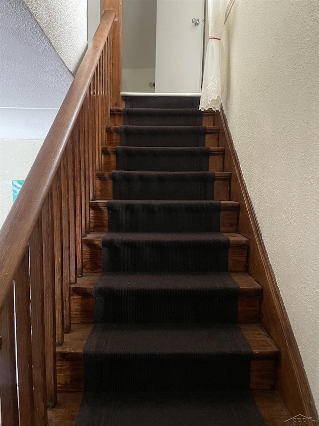 2205 Owen St, Saginaw, MI 48601 - stairs featuring a textured wall and wood finished floors