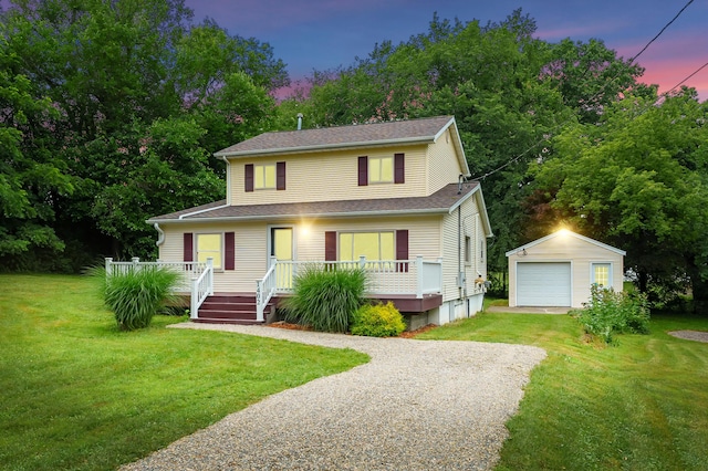 1402 Gracel St, Jackson, MI 49202 - view of front of home with an outbuilding, driveway, a deck, a garage, and a lawn