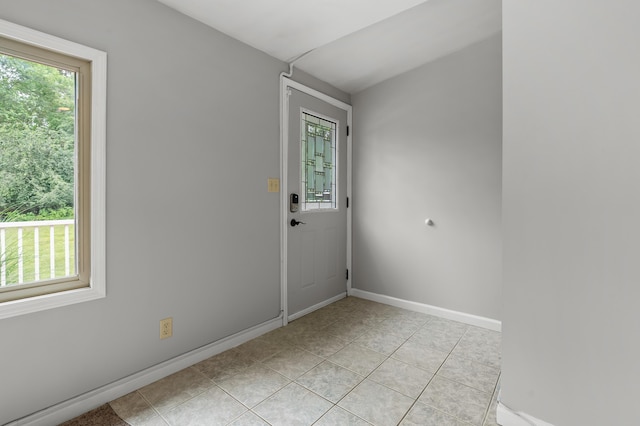 1402 Gracel St, Jackson, MI 49202 - spare room featuring light tile patterned flooring and baseboards