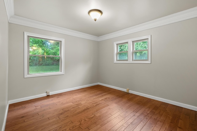 1402 Gracel St, Jackson, MI 49202 - spare room featuring ornamental molding and wood-type flooring