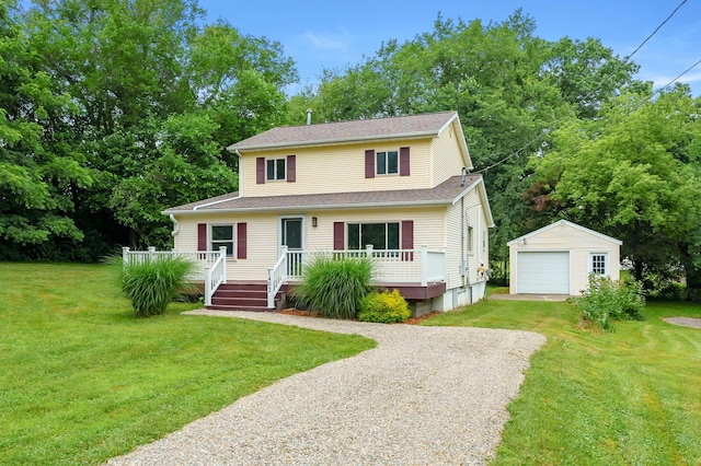 1402 Gracel St, Jackson, MI 49202 - view of front of home with gravel driveway, an outbuilding, a detached garage, a deck, and a front lawn
