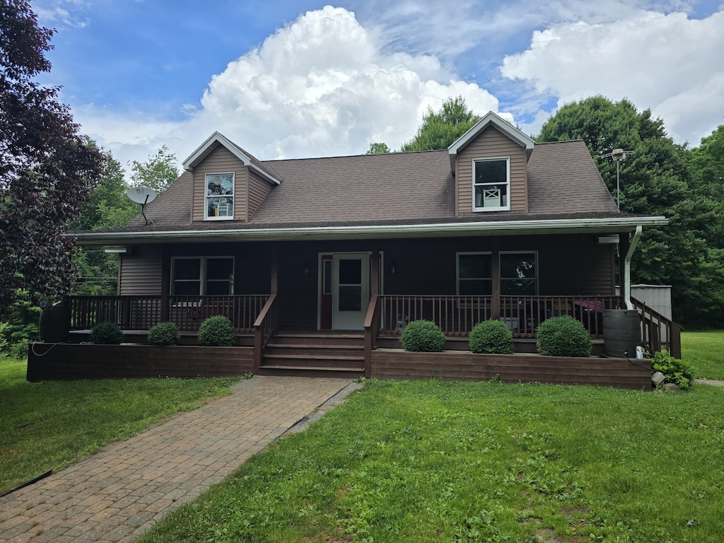 7425 Moeckel Rd, Grass Lake, MI 49240 - view of front of property with a front yard, a porch, and roof with shingles
