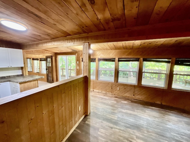 18572 Oxbow Dr, Barryton, MI 49305 - kitchen featuring wood ceiling, wooden walls, white cabinets, and hardwood / wood-style flooring
