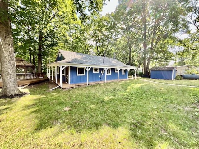 18572 Oxbow Dr, Barryton, MI 49305 - rear view of property featuring a gazebo, a lawn, a storage shed, a shingled roof, and view of wooded area