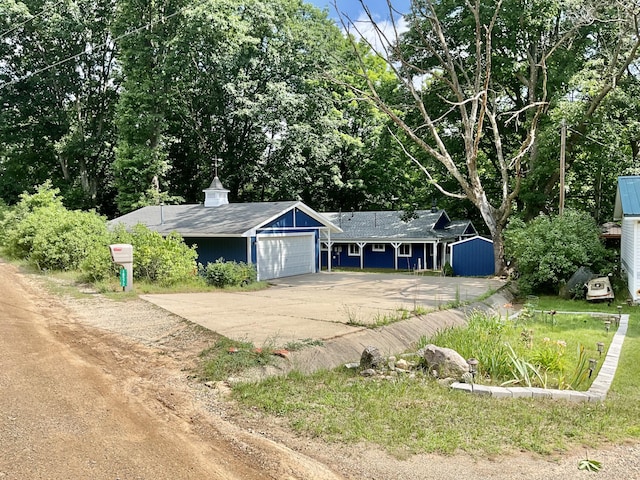 18572 Oxbow Dr, Barryton, MI 49305 - ranch-style house with concrete driveway and an attached garage