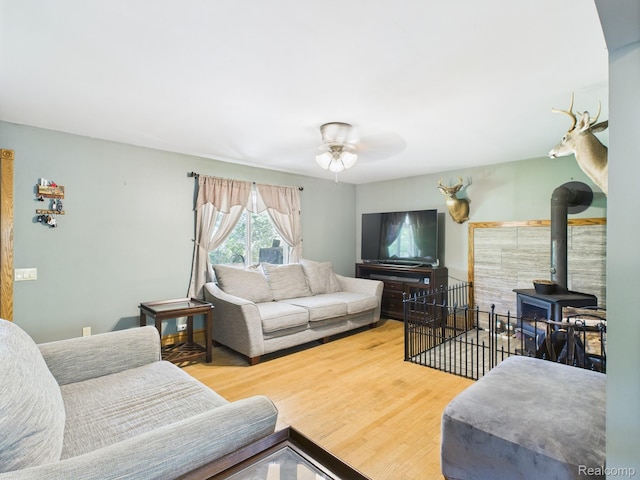 193 Miller Lake Rd, Columbiaville, MI 48421 - living area with ceiling fan, wood finished floors, and a wood stove