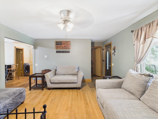 193 Miller Lake Rd, Columbiaville, MI 48421 - living room featuring a ceiling fan, washer / clothes dryer, and light wood finished floors