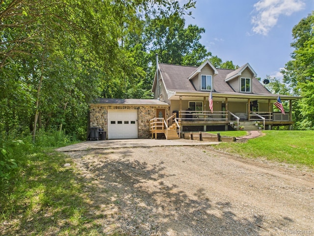 193 Miller Lake Rd, Columbiaville, MI 48421 - view of front of property with dirt driveway, a garage, a porch, and stone siding
