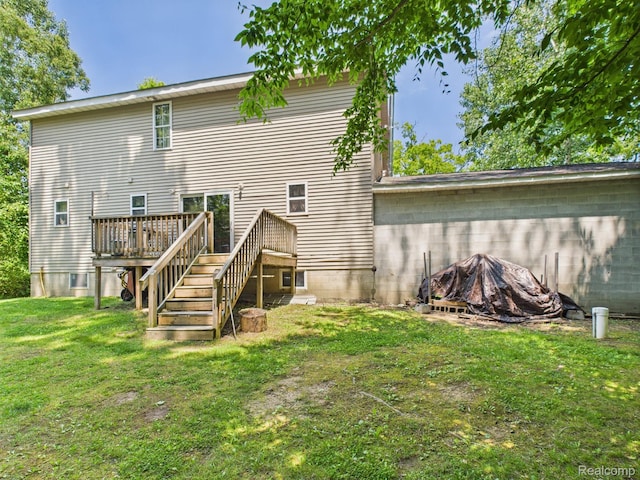 193 Miller Lake Rd, Columbiaville, MI 48421 - back of house featuring a wooden deck, a lawn, an outdoor fire pit, and stairs