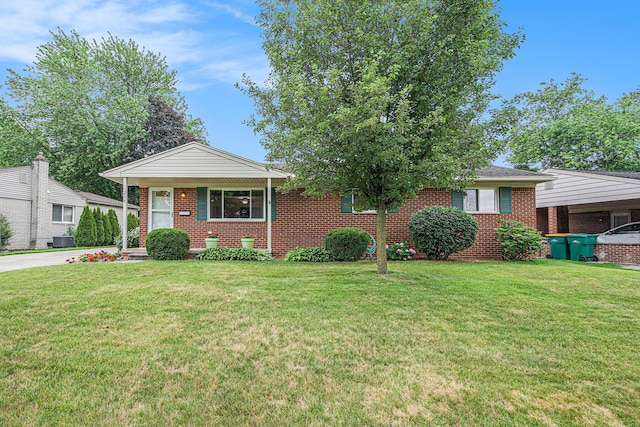256 Nichols Dr, Saline, MI 48176 - view of front of house featuring brick siding, a front lawn, and driveway
