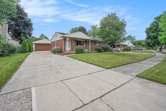 256 Nichols Dr, Saline, MI 48176 - single story home featuring brick siding, an outdoor structure, a front yard, and a detached garage