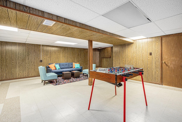 256 Nichols Dr, Saline, MI 48176 - recreation room featuring light floors, a drop ceiling, and wooden walls
