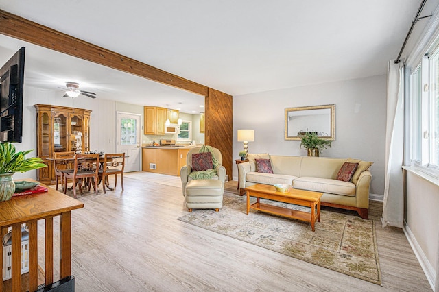 256 Nichols Dr, Saline, MI 48176 - living room with light wood-style floors, a ceiling fan, and beamed ceiling