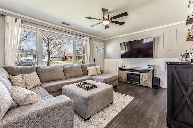 405 Spring St, Saline, MI 48176 - living room featuring a decorative wall, ceiling fan, dark wood-style floors, ornamental molding, and wainscoting