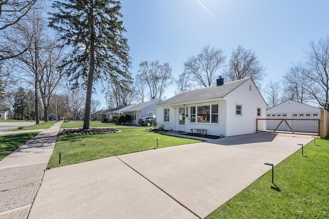 405 Spring St, Saline, MI 48176 - view of front of property with a front yard, a chimney, an outdoor structure, a garage, and a shingled roof