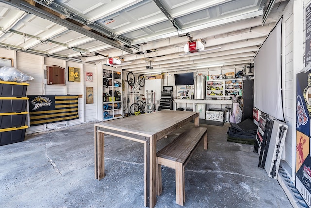405 Spring St, Saline, MI 48176 - garage with a garage door opener and a workshop area