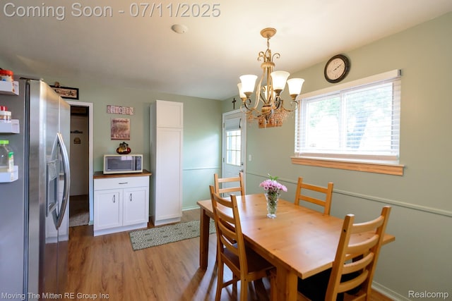 13620 Aston St, Romulus, MI 48174 - dining area with light wood-type flooring and a chandelier