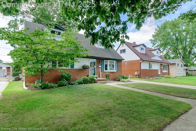 13620 Aston St, Romulus, MI 48174 - view of front of property with brick siding, a front yard, and a shingled roof
