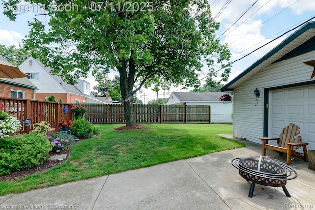 13620 Aston St, Romulus, MI 48174 - fenced backyard with an outdoor fire pit and a patio