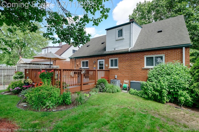 13620 Aston St, Romulus, MI 48174 - rear view of house featuring brick siding, a deck, roof with shingles, and a chimney