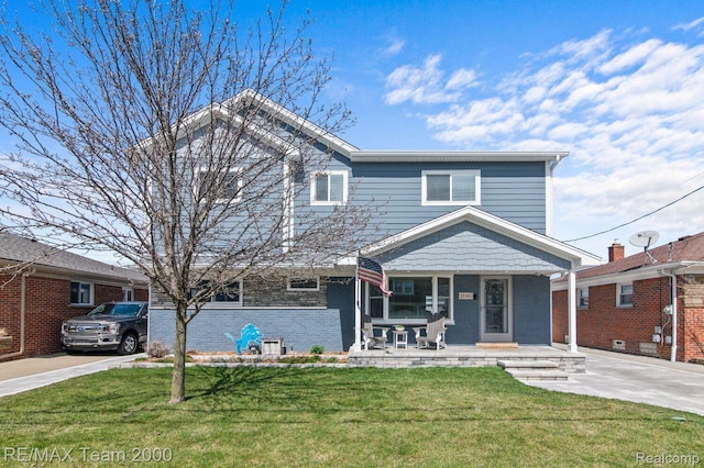 22543 E 11 Mile Rd, Saint Clair Shores, MI 48081 - view of front of home with covered porch, a front yard, and brick siding