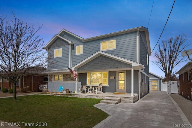 22543 E 11 Mile Rd, Saint Clair Shores, MI 48081 - view of front facade featuring a gate, a porch, and brick siding