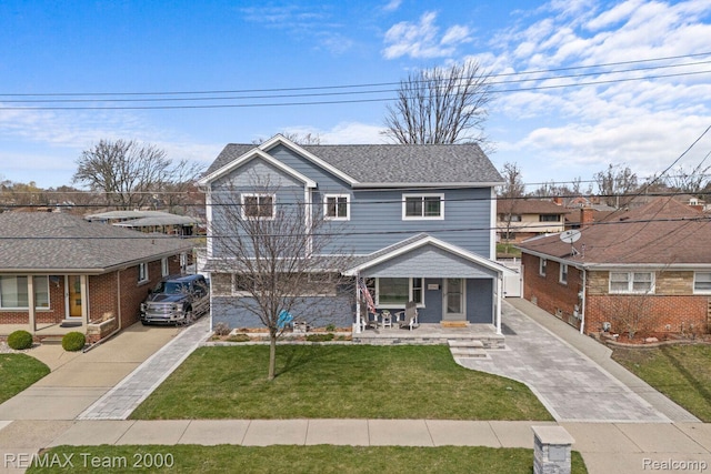22543 E 11 Mile Rd, Saint Clair Shores, MI 48081 - view of front of home with a porch, concrete driveway, and a front lawn
