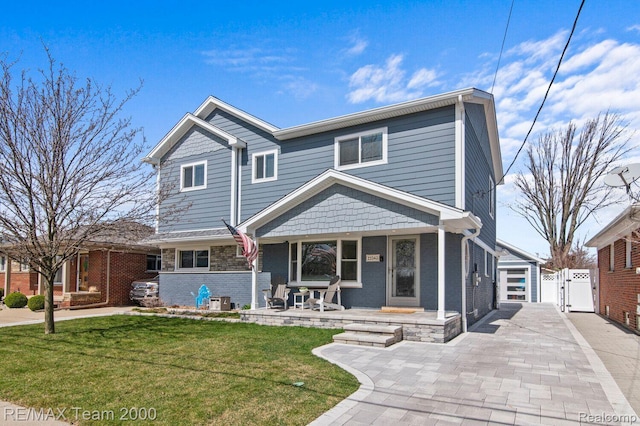 22543 E 11 Mile Rd, Saint Clair Shores, MI 48081 - view of front facade featuring a gate, covered porch, and brick siding