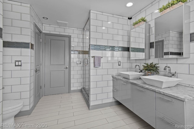22543 E 11 Mile Rd, Saint Clair Shores, MI 48081 - full bathroom featuring tile walls, double vanity, tile patterned floors, a shower stall, and recessed lighting